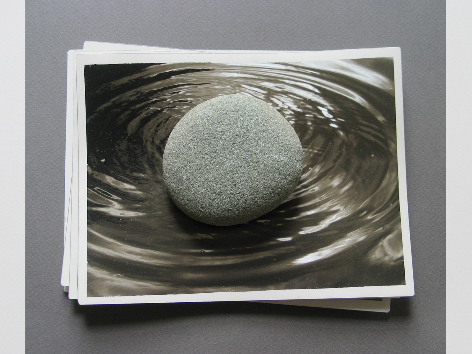 If / Then. Stone on a stack of archival pigment prints. 2011.